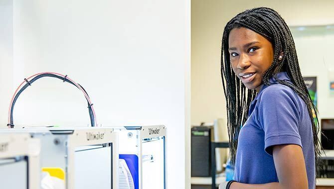 MCDS student near a water refill station during a campus tour