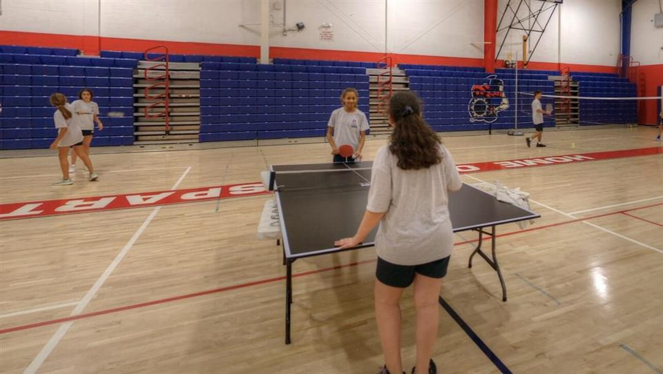 Students playing table tennis during an MCDS campus tour stop