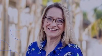 Smiling MCDS female faculty member wearing glasses outdoors