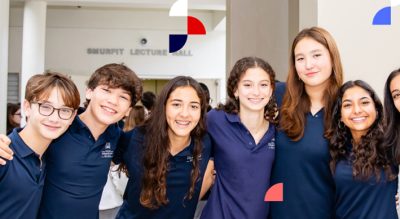 Group of MCDS students smiling together inside a school