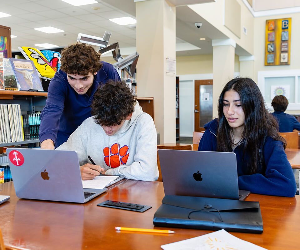 MCDS students collaborating on a laptop in class