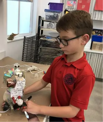 MCDS student soldering electronics for a robotics project