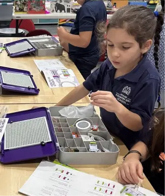 MCDS students assembling robotics components in class