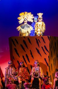 MCDS Theater student in costume seated on stage