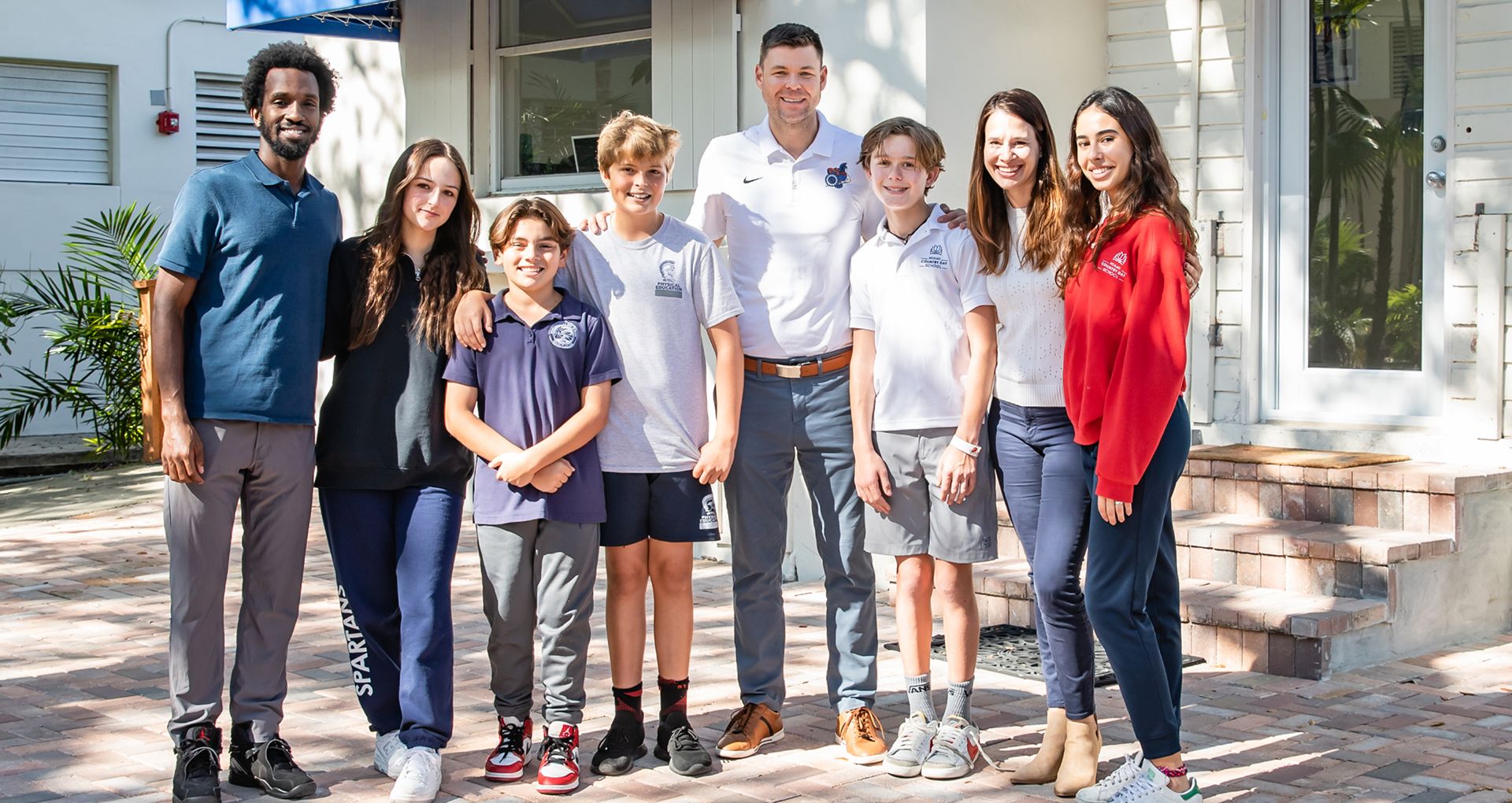 MCDS families posing together outside the Academic Success and Wellbeing building