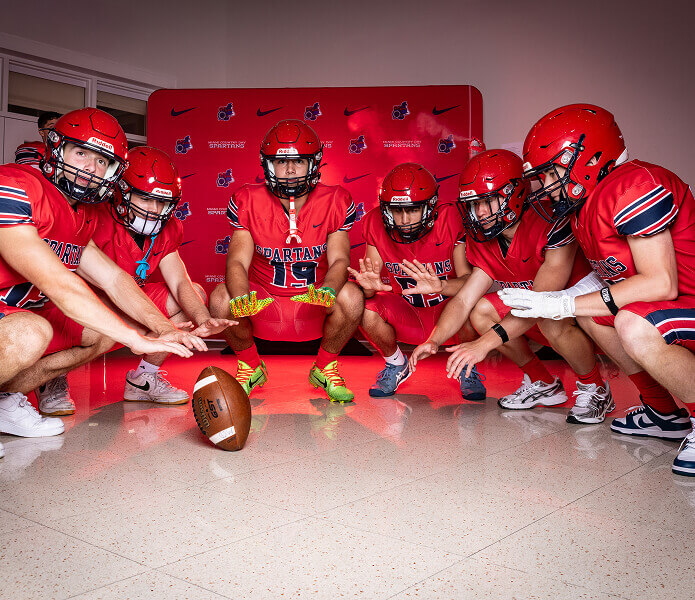 MCDS football team huddled together on the field