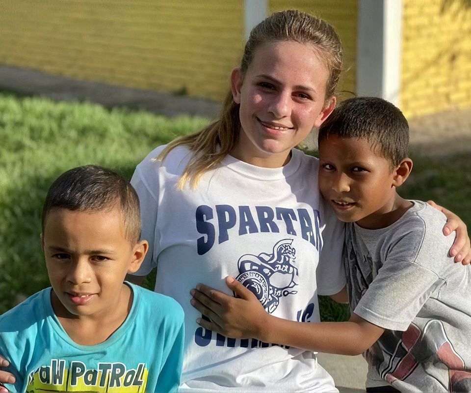 MCDS student with children during a GLOBE international exchange trip