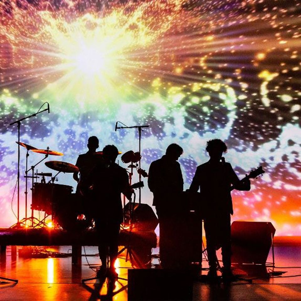 MCDS Music students silhouetted on stage at sunset