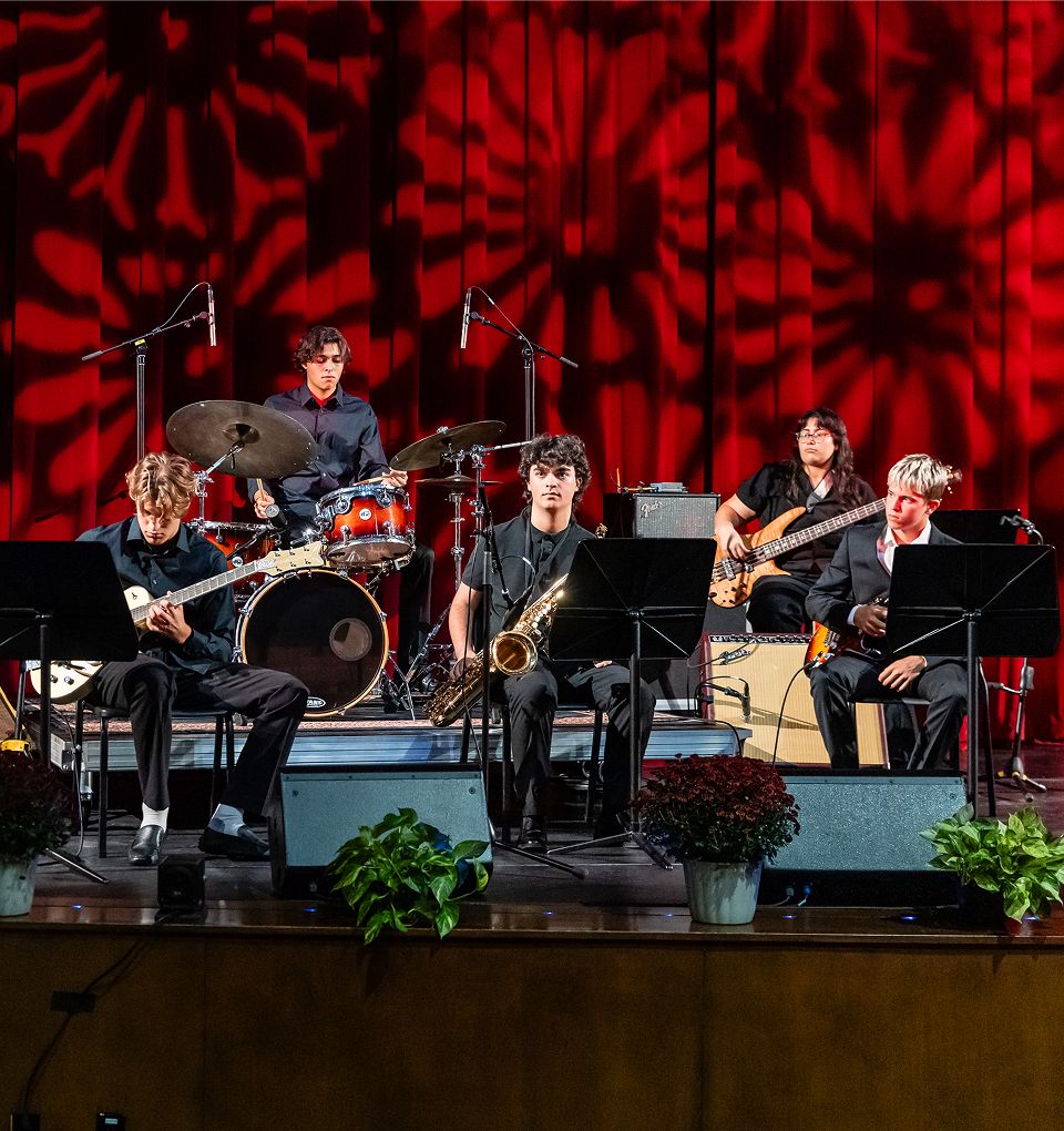 MCDS student band performing on stage at the Arts Hall of Fame event