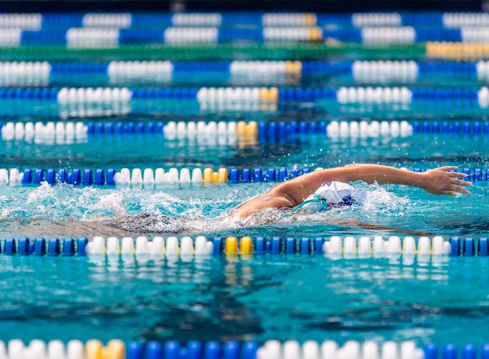 MCDS swim team member competing in a freestyle stroke during aquatics practice