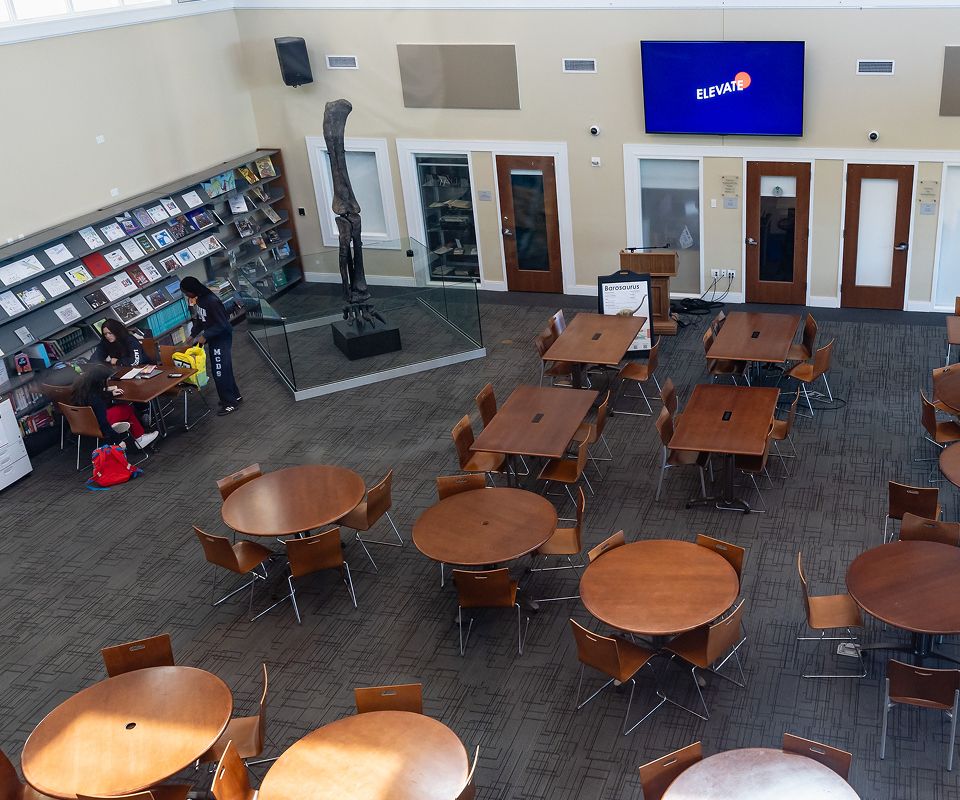 Indoor seating area with round tables and chairs
