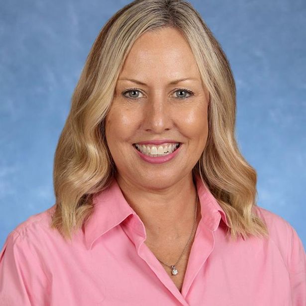 Female MCDS staff member smiling in a professional school portrait