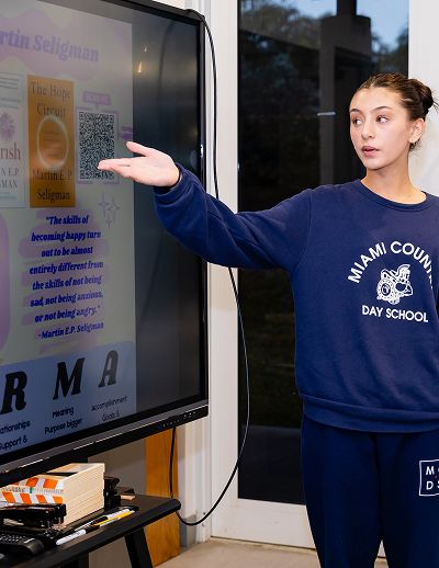 Upper School teacher presenting at a display screen
