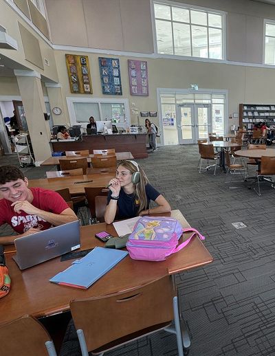 Students working at tables in an open study area