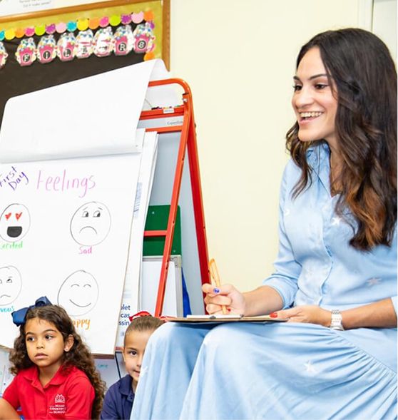 MCDS staff member writing on a whiteboard
