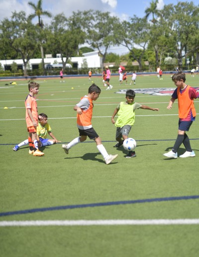 MCDS summer camp students playing soccer during an outdoor sports clinic