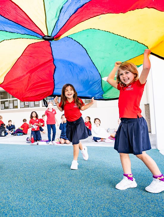 MCDS Lower School students playing with a parachute for Wellness activities