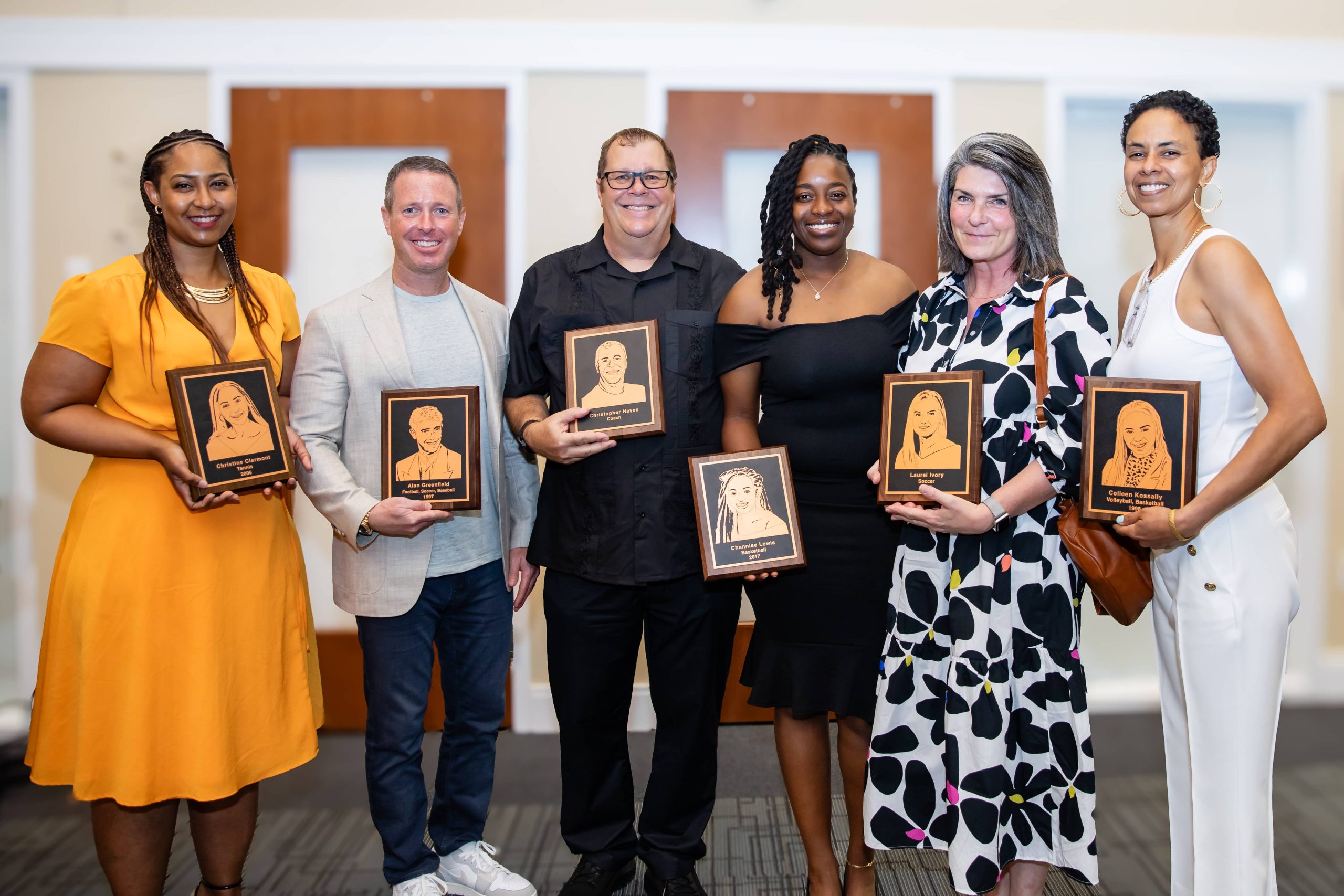 MCDS Hall of Fame honorees posing together with plaques