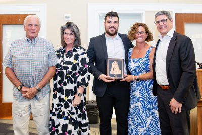 MCDS Hall of Fame honorees posing together with a plaque