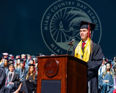 MCDS graduate speaking at the podium during the 2026 Commencement ceremony