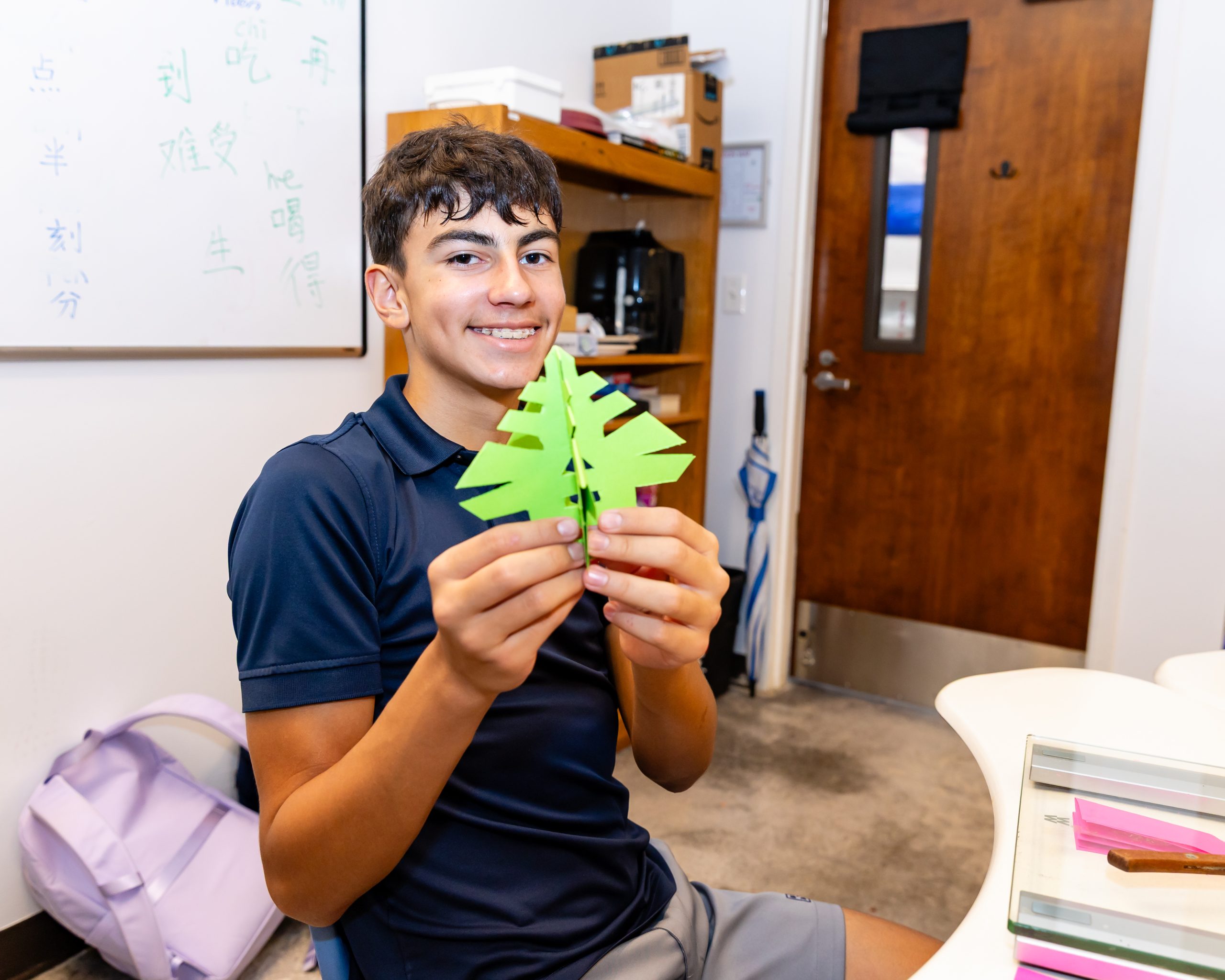 MCDS Middle School student holding a classroom craft project