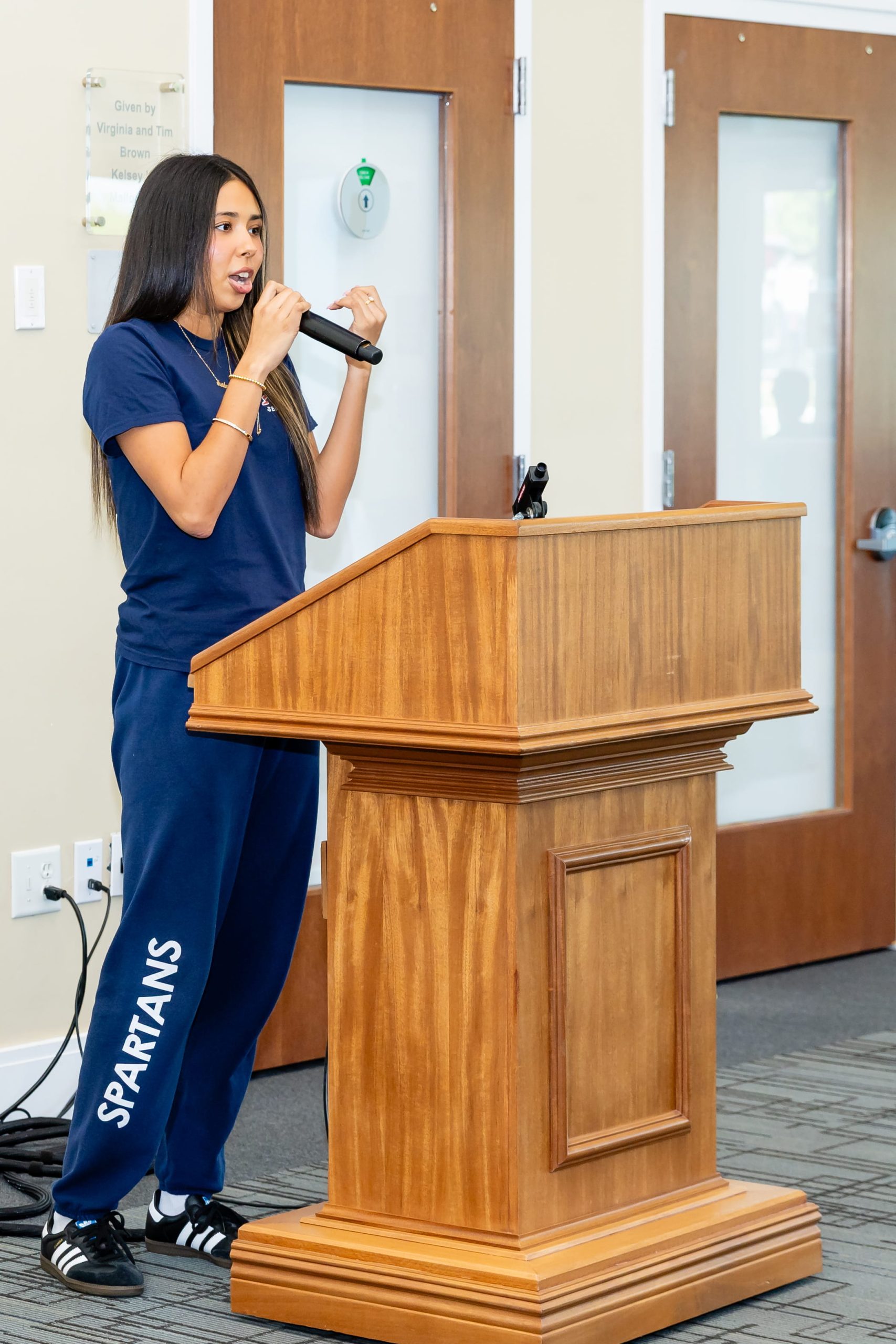 MCDS Upper School student speaking at a podium