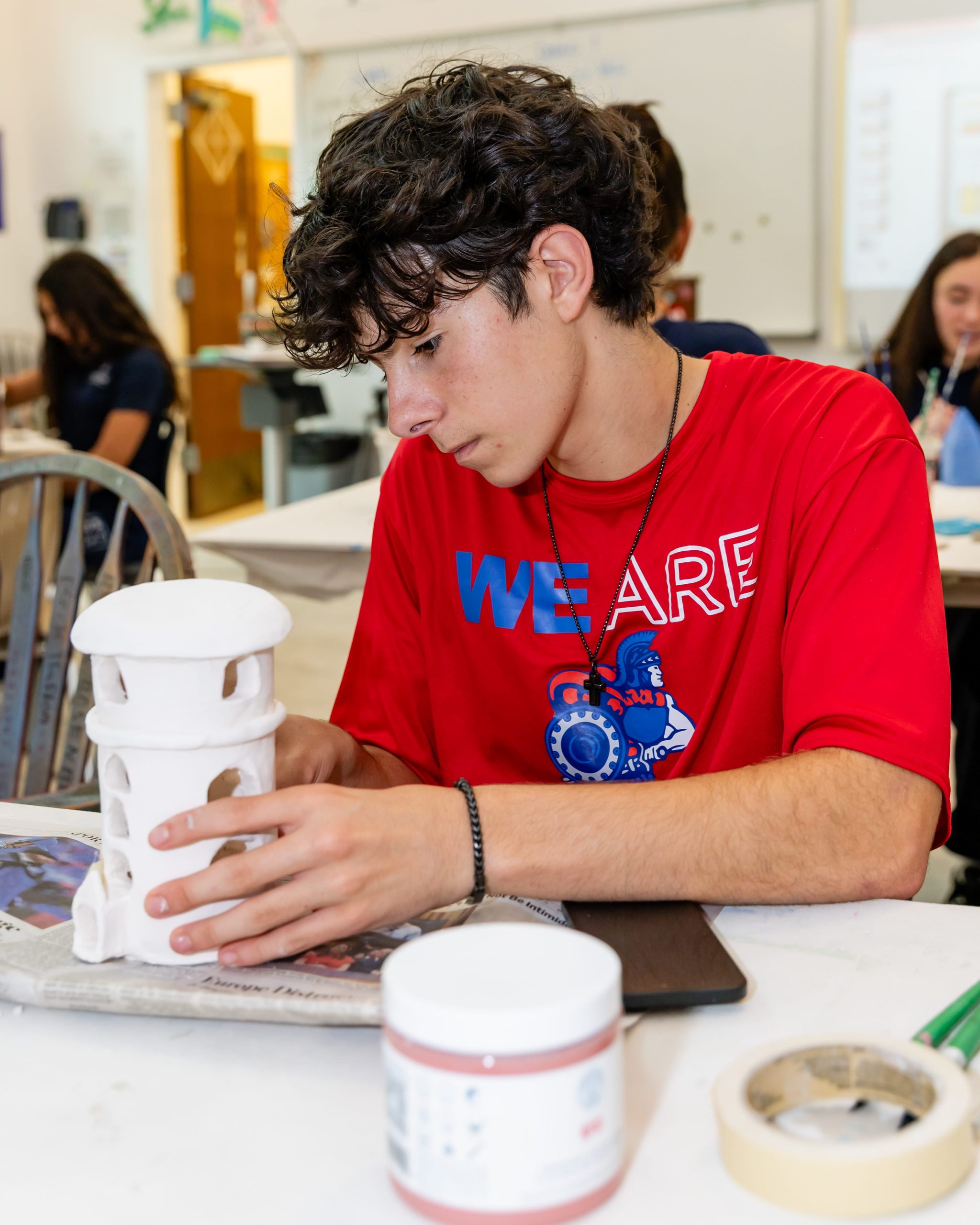 MCDS Upper School student working with art materials, shown on the Visual Arts page