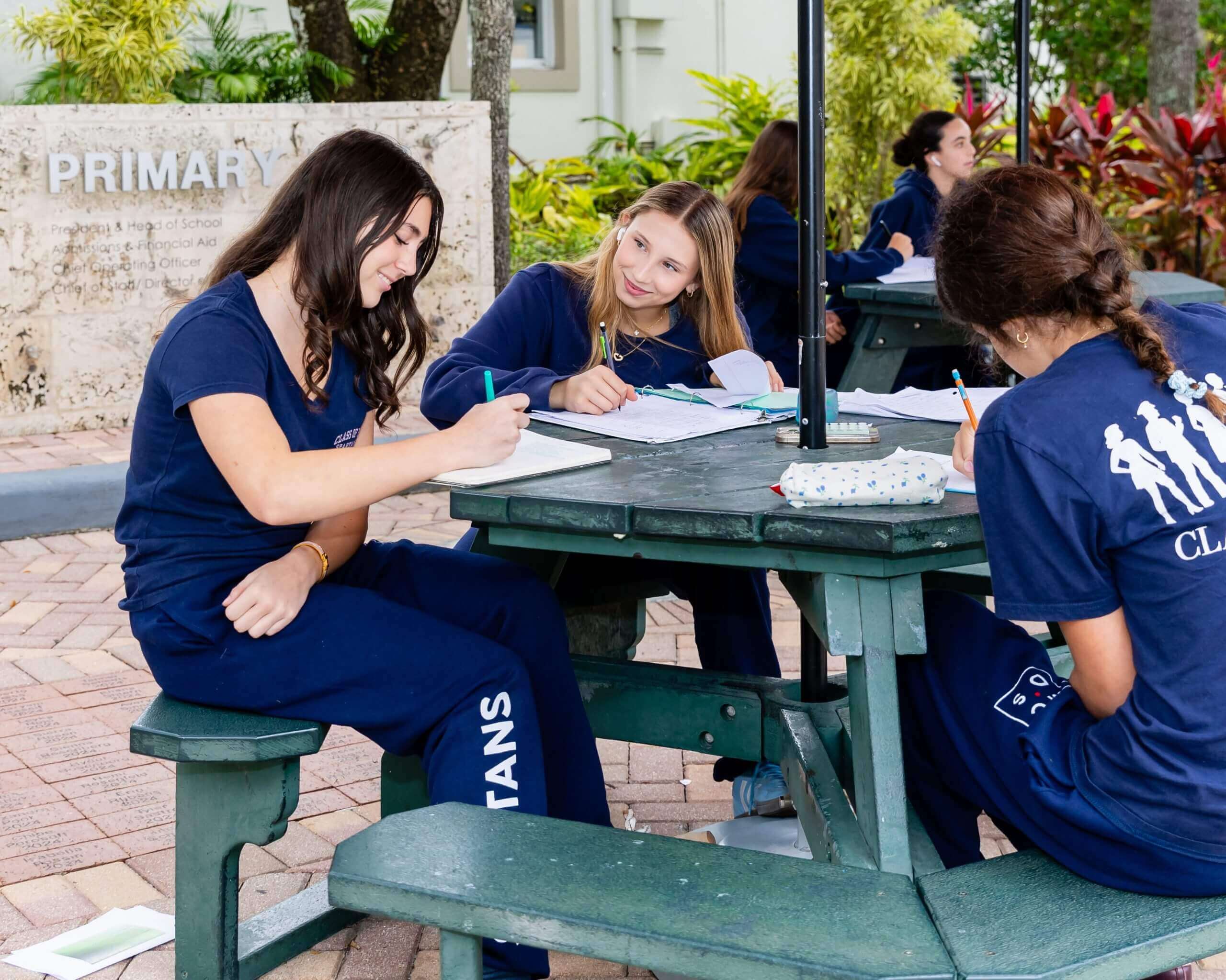 MCDS students working together at an outdoor picnic table