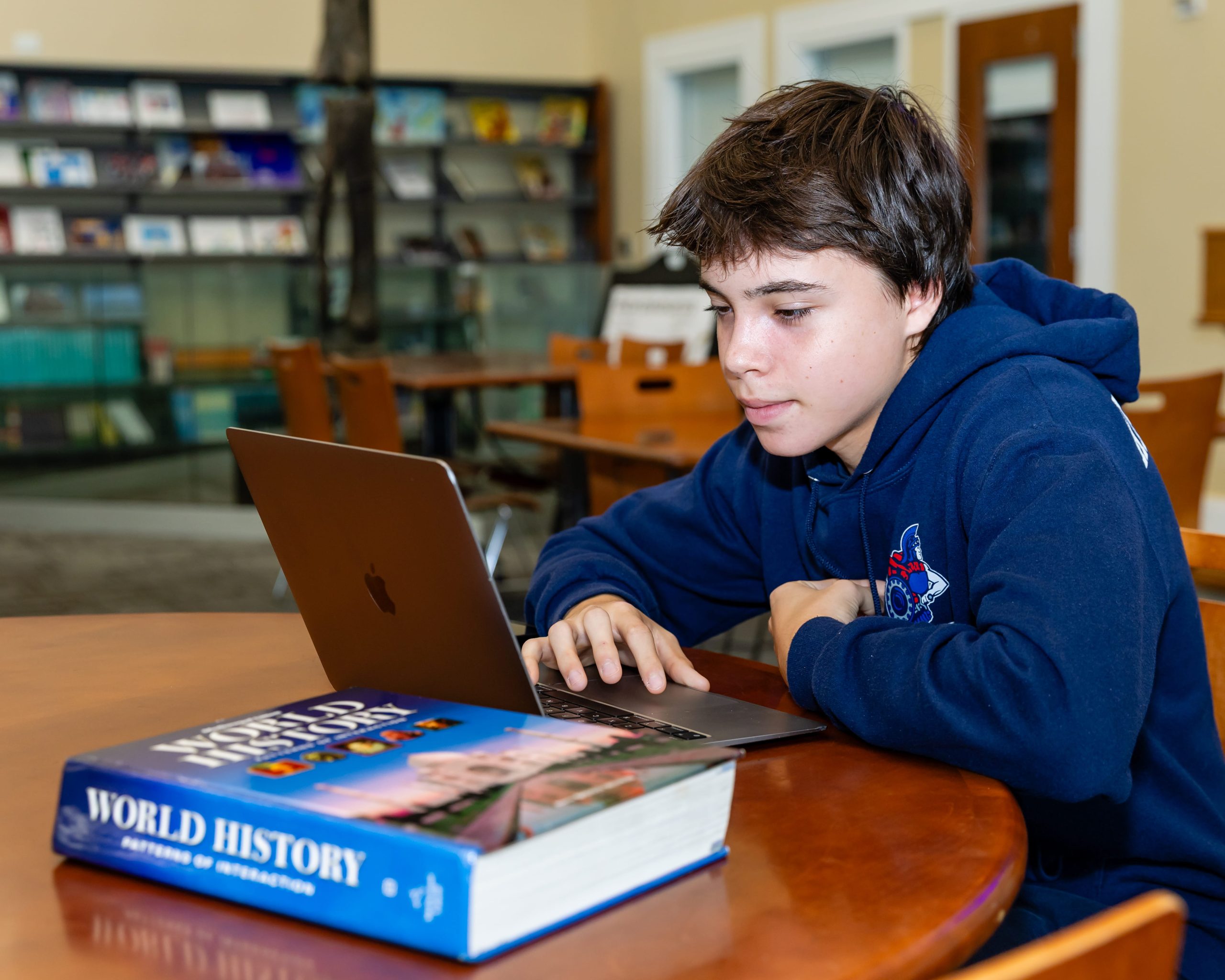 MCDS student reading a book at a desk