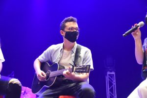 MCDS Upper School student playing guitar during a musical performance