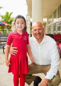 MCDS alumnus with a child at the Alumni Breakfast event