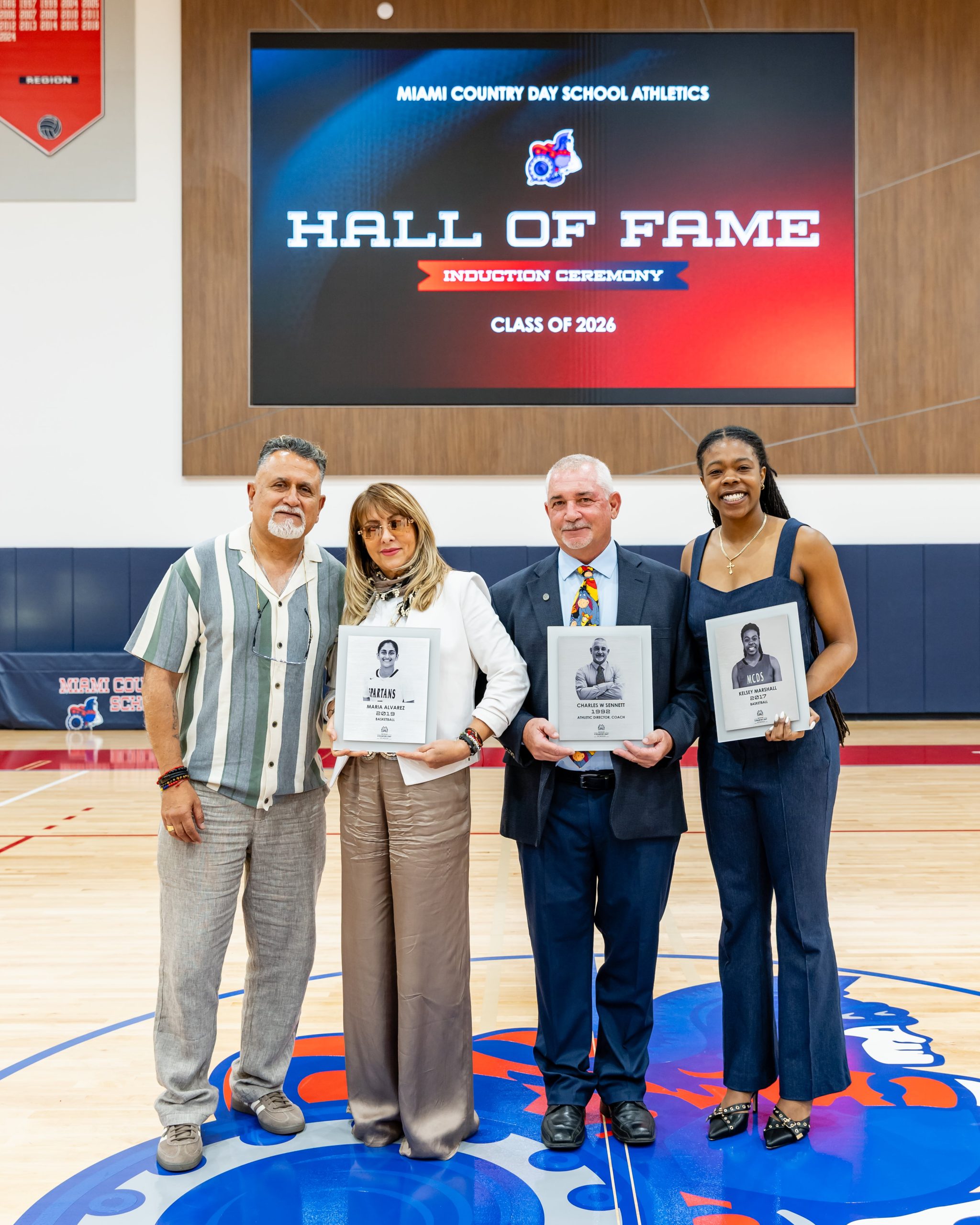 Spartan Athletics Hall of Fame banner with honorees on the court