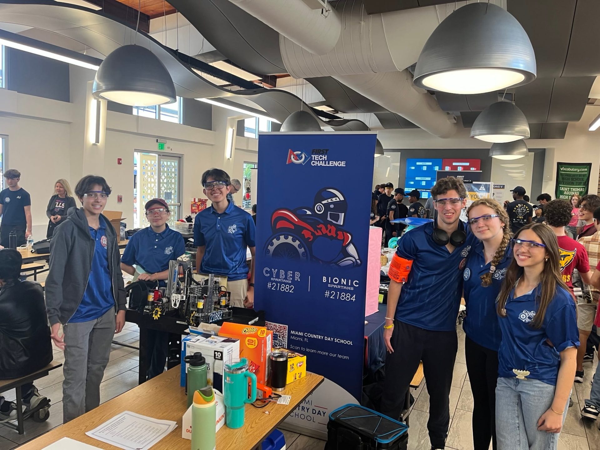MCDS Robotics Team at an event booth, Giving page card