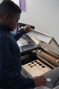 MCDS student working with an electronic keyboard, shown on the EI² Honor Society page