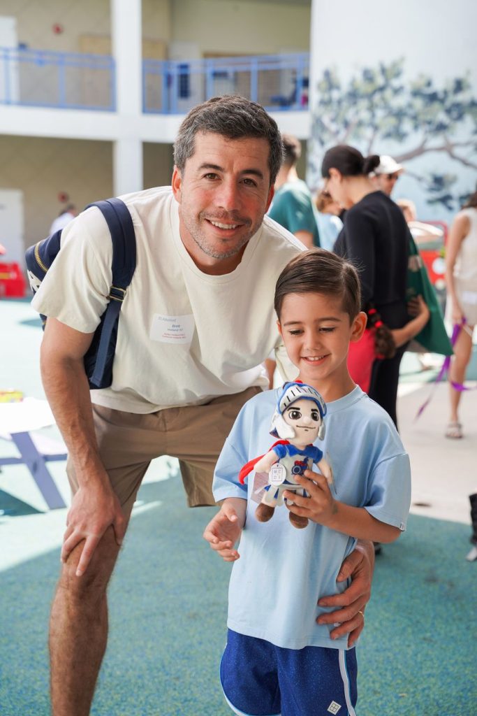 Father and son with the MCDS Spartan mascot