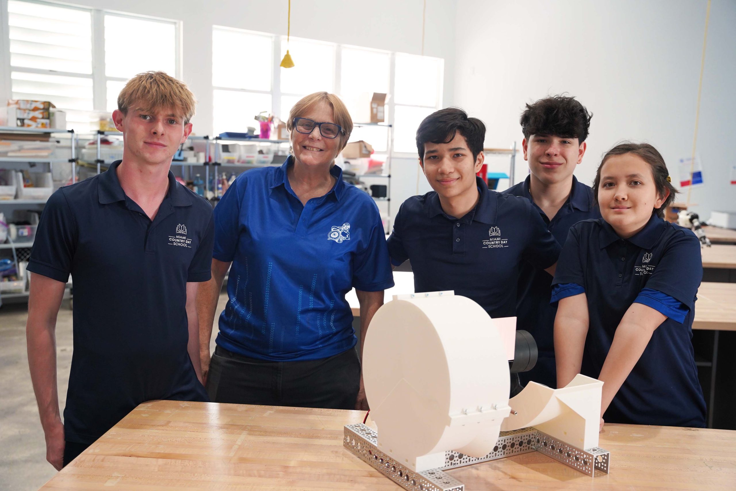 MCDS Robotics Team members holding a robot model