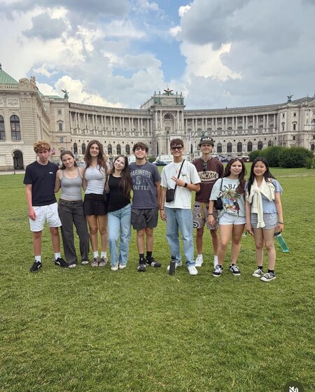 MCDS students sitting together outdoors, GATEway trip photo