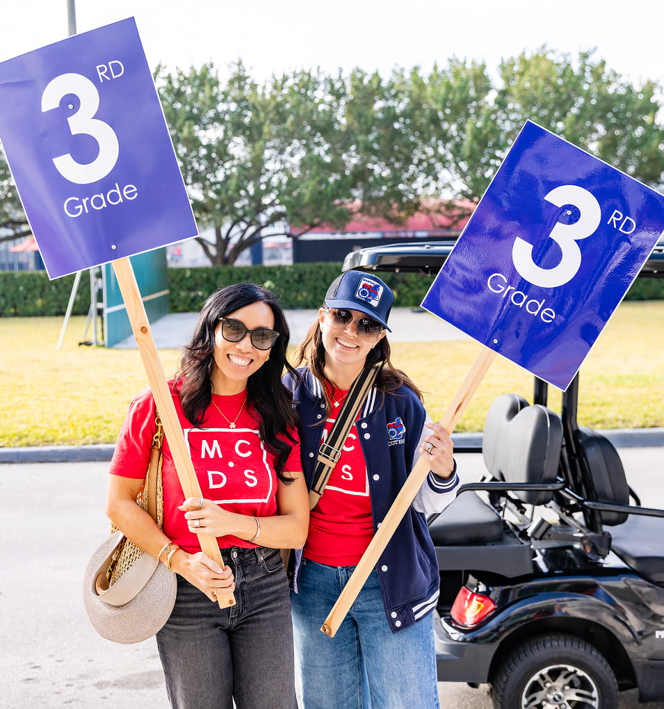 MCDS students holding number flags during a Giving campaign event