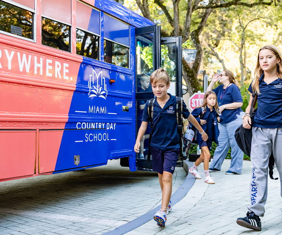Students boarding the MCDS Spartan school bus