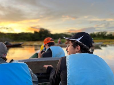 MCDS students on a boat excursion at sunset, part of the Signature Programs