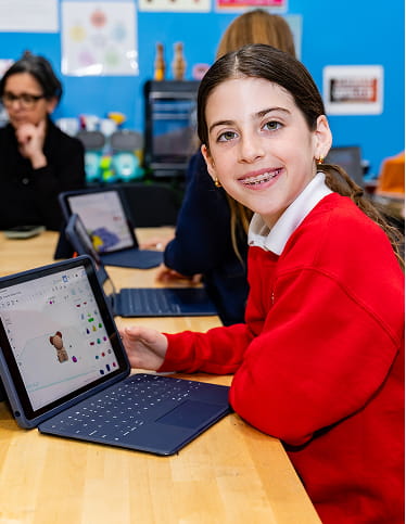 MCDS student and staff member looking at a tablet together