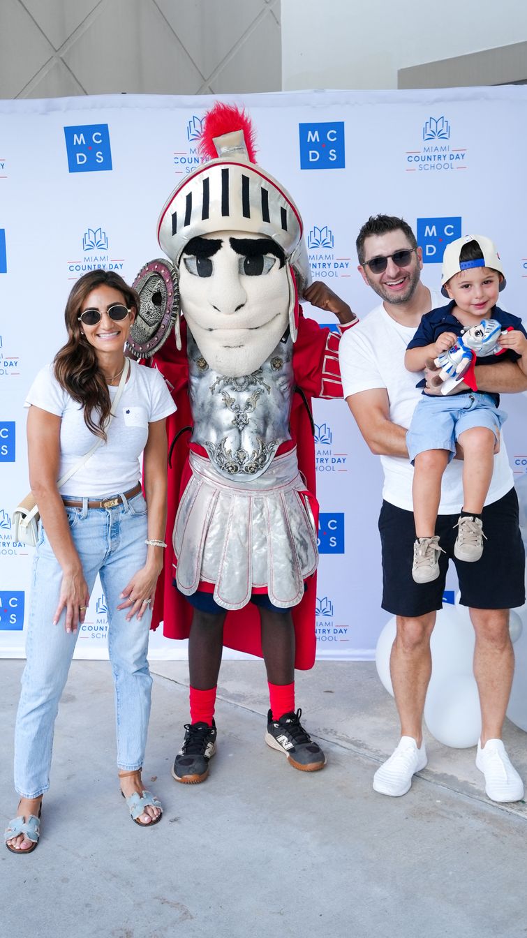 Students posing with the Spartan mascot at an enrolment event